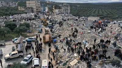 An aerial view shows civil defense workers and residents search through the rubble following a massive earthquake in the town of Harem near the Turkish border.&nbsp; (AP)