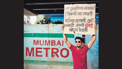 Chetan Kolge, who is famously known as ‘Poster Boy Chetan’, uses humorous handmade posters to highlight civic issues in still images. Kolge filmed himself sitting inside a pothole holding up a poster proclaiming ‘We are ready to use helmet for the pillion riders, are you ready to give us better roads?’ It became a talking point on social media. (HT PHOTO) Chetan Kolge, who is famously known as ‘Poster Boy Chetan’, uses humorous handmade posters to highlight civic issues in still images. Kolge filmed himself sitting inside a pothole holding up a poster proclaiming ‘We are ready to use helmet for the pillion riders, are you ready to give us better roads?’ It became a talking point on social media. (HT PHOTO)