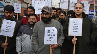 Jammu and Kashmir Awami Awaz Party supporters display placards during protest against the new land policy in Srinagar,on Monday. (Waseem Andrabi /HT) Jammu and Kashmir Awami Awaz Party supporters display placards during protest against the new land policy in Srinagar,on Monday. (Waseem Andrabi /HT)