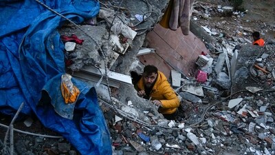 A man searches for people in a destroyed building in Adana, Turkey. (AP)