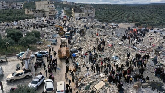 An aerial view shows civil defense workers and residents search through the rubble following a massive earthquake in the town of Harem near the Turkish border.&nbsp;(AP)