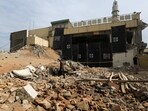 A man walks amid the rubble, days after a suicide blast in a mosque in Peshawar, 