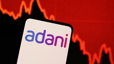 Adani logo and decreasing stock graph is seen in this illustration. (REUTERS)