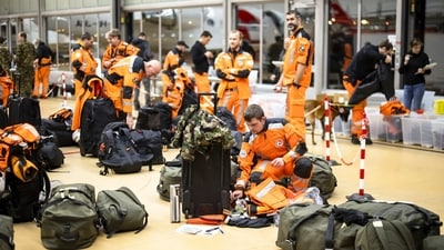 Swiss experts and rescuers with service dogs preparing to fly to the earthquake-hit Turkey, at Zurich Airport, Switzerland on Monday. (AP)