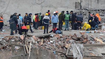 Rescue personnel search for victims and survivors through the rubble of buildings in Diyarbakir, the day after a 7.8-magnitude earthquake struck the country's southeast. (AFP)