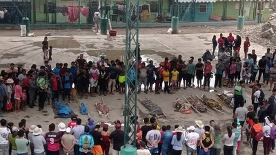 Peru Landslides: Residents stand around the bodies of persons who perished in recent landslides in Camana, Peru. (AP)