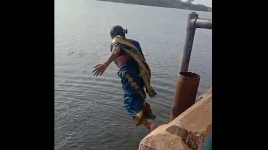 The image shows a elderly woman in saree diving in Tamil Nadu’s Thamirabarani River. (Twitter@supriyasahuias)