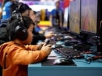 Attendees play Roller Champions by UbiSoft Entertainment at the Paris Games Week (PGW), a trade fair for video games in Paris, France. Video games neither harm nor benefit kid's mind? New study makes parents rethink 