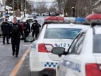 Laval police vehicles mark a road block along Dufferin Terrace where in the morning a Laval city bus crashed into the Garderie Educative Sainte-Rose, in Laval, Quebec, Canada.