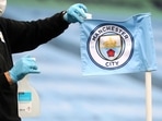 FILE - A groundsman disinfects a corner flag ahead of the English Premier League soccer match between Manchester City and Burnley at Etihad Stadium, in Manchester, England, Monday, June 22, 2020. Manchester City has been accused of numerous breaches of the Premier League's financial regulations between 2009-18. The period covers the first nine full seasons under the club's Abu Dhabi ownership. City won the league on three occasions during that time in 2012, 2014 and 2018. (AP Photo/Martin Rickett,Pool, File) FILE - A groundsman disinfects a corner flag ahead of the English Premier League soccer match between Manchester City and Burnley at Etihad Stadium, in Manchester, England, Monday, June 22, 2020. Manchester City has been accused of numerous breaches of the Premier League's financial regulations between 2009-18. The period covers the first nine full seasons under the club's Abu Dhabi ownership. City won the league on three occasions during that time in 2012, 2014 and 2018. (AP Photo/Martin Rickett,Pool, File)
