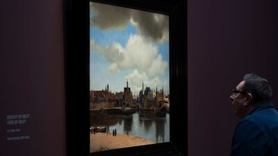 A man looks at “View of Delft” at Amsterdam's Rijksmuseum, on February 6. "For me personally Vermeer is one of the greatest artists in the world," said Gregor Weber, the Rijksmuseum's fine arts department head and author of a recent book showing Vermeer was influenced by a pinhole camera that was first introduced to him by Jesuit priests. "To have three-quarters of his oeuvre together here in Amsterdam under one roof is the crown of my work." (Peter Dejong / AP ) A man looks at “View of Delft” at Amsterdam's Rijksmuseum, on February 6. "For me personally Vermeer is one of the greatest artists in the world," said Gregor Weber, the Rijksmuseum's fine arts department head and author of a recent book showing Vermeer was influenced by a pinhole camera that was first introduced to him by Jesuit priests. "To have three-quarters of his oeuvre together here in Amsterdam under one roof is the crown of my work." (Peter Dejong / AP )
