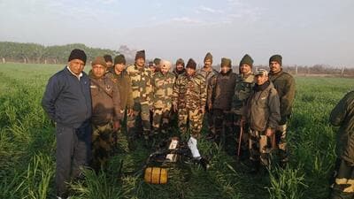 Border Security Force personnel with the drone that was shot down near Rear Kakkar border outpost in Amritsar district on February 3. The drone was carrying 5kg of heroin, which was also recovered. (HT file photo)