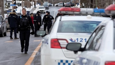 Laval police vehicles mark a road block along Dufferin Terrace where in the morning a Laval city bus crashed into the Garderie Educative Sainte-Rose, in Laval, Quebec, Canada. (REUTERS)