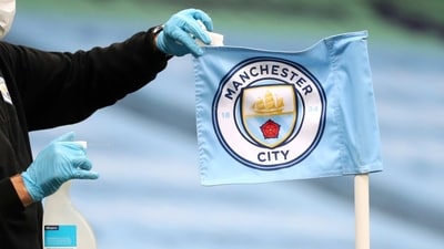 FILE - A groundsman disinfects a corner flag ahead of the English Premier League soccer match between Manchester City and Burnley at Etihad Stadium, in Manchester, England, Monday, June 22, 2020. Manchester City has been accused of numerous breaches of the Premier League's financial regulations between 2009-18. The period covers the first nine full seasons under the club's Abu Dhabi ownership. City won the league on three occasions during that time in 2012, 2014 and 2018. (AP Photo/Martin Rickett,Pool, File) (AP) FILE - A groundsman disinfects a corner flag ahead of the English Premier League soccer match between Manchester City and Burnley at Etihad Stadium, in Manchester, England, Monday, June 22, 2020. Manchester City has been accused of numerous breaches of the Premier League's financial regulations between 2009-18. The period covers the first nine full seasons under the club's Abu Dhabi ownership. City won the league on three occasions during that time in 2012, 2014 and 2018. (AP Photo/Martin Rickett,Pool, File) (AP)