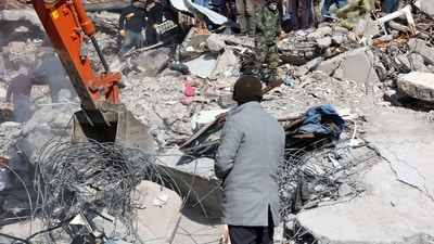 A man looks as rescuers and civilians look for survivors under the rubble of collapsed buildings in Kahramanmaras, on February 8, 2023. (AFP) A man looks as rescuers and civilians look for survivors under the rubble of collapsed buildings in Kahramanmaras, on February 8, 2023. (AFP)