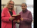 Lesley Harrison returning the book to the library after 56 years.
