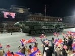A missile is displayed as North Korean leader Kim Jong Un is seen on large screens during a military parade to mark the 75th founding anniversary of North Korea's army, 