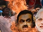 A Congress party activist burns an effigy of PM Modi and Gautam Adani during a protest rally in Kolkata on Monday. (AFP)