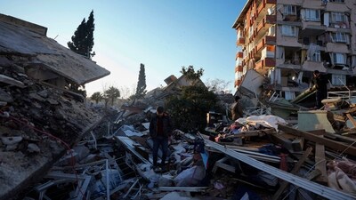 Turkey Earthquake: A man walks through the rubble of destroyed buildings in Antakya, southern Turkey. (AP)