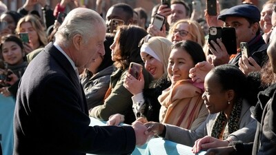 Britain's King Charles III shakes hands with students as he visits the University of East London to mark the University's 125th anniversary and open a new frontline medical teaching hub in east London. (AFP)