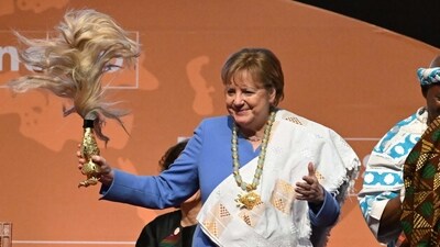 Former German Chancellor Angela Merkel gestures after receiving the Felix Houphouet-Boigny Peace Prize. (AFP)