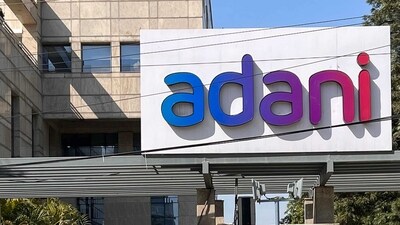 Employees walk past the Adani House corporate building at the institutional area in Gurugram on February 8, 2023. - Shares in the flagship firm of troubled Indian conglomerate Adani rose almost 15 percent on February 7, clawing back some of its recent huge losses after saying it would repay more than $1 billion in loans. (Photo by Sajjad HUSSAIN / AFP) (AFP)