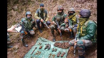 Indian army personnel display arms and ammunition recovered from a militant hideout in Mendhar area of Poonch district on Thursday. (PTI) Indian army personnel display arms and ammunition recovered from a militant hideout in Mendhar area of Poonch district on Thursday. (PTI)