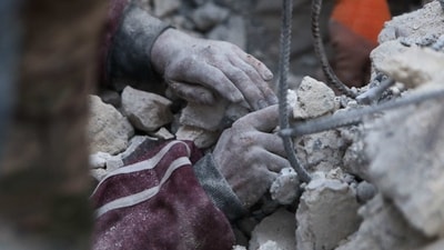 Turkey Earthquake: A rescue worker digs to reach a boy under the rubble. (AFP) Turkey Earthquake: A rescue worker digs to reach a boy under the rubble. (AFP)