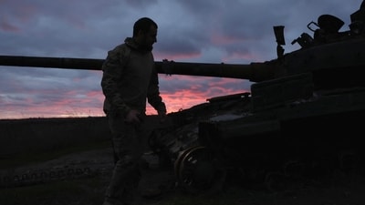 Russia-Ukraine War: A Ukrainian serviceman walks near a destroyed tank at sunset, as Russia's invasion of Ukraine continues, near Izium, Ukraine. (Reuters)