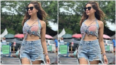 Aamna picked a blue cropped top with a sweetheart neckline, sleeveless details, multicoloured details, corset patterns and a knot in the middle. She teamed it with a pair of blue distressed denim shorts. (Instagram/@aamnasharifofficial) Aamna picked a blue cropped top with a sweetheart neckline, sleeveless details, multicoloured details, corset patterns and a knot in the middle. She teamed it with a pair of blue distressed denim shorts. (Instagram/@aamnasharifofficial)