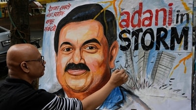 An artist gives final touches to a painting of Gautam Adani, depicting the ongoing crisis of the Adani group, in Mumbai, (AP) An artist gives final touches to a painting of Gautam Adani, depicting the ongoing crisis of the Adani group, in Mumbai, (AP)