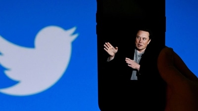 An illustration photo shows a phone screen displaying a photo of Elon Musk with the Twitter logo shown in the background. (AFP) An illustration photo shows a phone screen displaying a photo of Elon Musk with the Twitter logo shown in the background. (AFP)