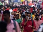 In this photograph taken on October 31, 2022, people walk through a crowded commercial street in Chennai. - India is projected to see an explosion in its urban population in the coming decades, but its cities already cannot cope and climate change will make living conditions harsher still. (Photo by Arun SANKAR / AFP) / To go with 'India-Population-Climate-Health', FOCUS