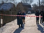 Residents wait behind police cordon to return to their homes after a rocket attack in Kyiv suburbs, Ukraine, Friday. Residents wait behind police cordon to return to their homes after a rocket attack in Kyiv suburbs, Ukraine, Friday.