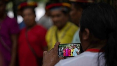 A Siekopai indigenous woman seen recording a video in the Amazon region in Lagartococha, on January 11. "New generations do not know this place, its history, its special energy. This meeting aims to strengthen the bonds between the elders and the young," added community leader Piyahuaje. (Pedro Pardo / AFP) A Siekopai indigenous woman seen recording a video in the Amazon region in Lagartococha, on January 11. "New generations do not know this place, its history, its special energy. This meeting aims to strengthen the bonds between the elders and the young," added community leader Piyahuaje. (Pedro Pardo / AFP)