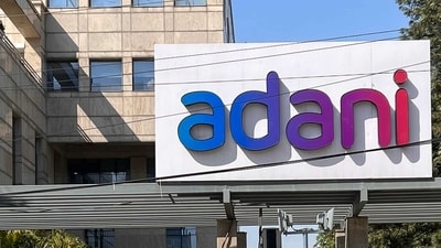 Employees walk past the Adani House corporate building at the institutional area in Gurugram on February 8, 2023. - Shares in the flagship firm of troubled Indian conglomerate Adani rose almost 15 percent on February 7, clawing back some of its recent huge losses after saying it would repay more than $1 billion in loans. (Photo by Sajjad HUSSAIN / AFP) (AFP) Employees walk past the Adani House corporate building at the institutional area in Gurugram on February 8, 2023. - Shares in the flagship firm of troubled Indian conglomerate Adani rose almost 15 percent on February 7, clawing back some of its recent huge losses after saying it would repay more than $1 billion in loans. (Photo by Sajjad HUSSAIN / AFP) (AFP)