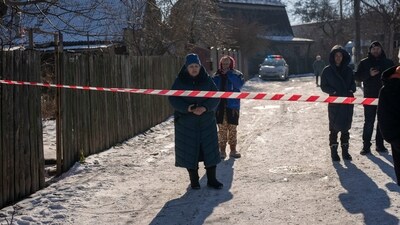 Residents wait behind police cordon to return to their homes after a rocket attack in Kyiv suburbs, Ukraine, Friday. (AP) Residents wait behind police cordon to return to their homes after a rocket attack in Kyiv suburbs, Ukraine, Friday. (AP)