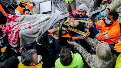 Rescuers carry 27-year-old survivor Rabia Ofkeli in the aftermath of a deadly earthquake in Hatay, Turkey, on Friday. (REUTERS)