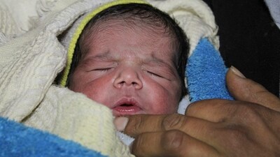 Fatmah Ahmad, holds her new born baby Najm al-Din Mahmoud, who was born on the same day of the earthquake, in Aleppo, Syria. (REUTERS)