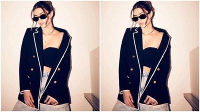 Kriti looked chic as ever in a black tube top featuring corset pattern. She further layered it with a black oversized blazer featuring white borders and golden buttons. (Instagram/@kritisanon) Kriti looked chic as ever in a black tube top featuring corset pattern. She further layered it with a black oversized blazer featuring white borders and golden buttons. (Instagram/@kritisanon)