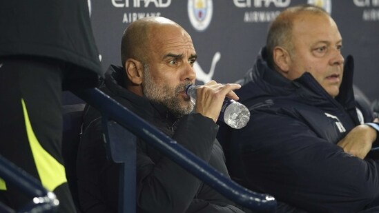 Manchester City's head coach Pep Guardiola sits on the bench before the English FA Cup 4th round match (AP)