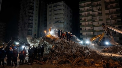 Rescue workers search for bodies and earthquake survivors on a collapsed building in Adana, southeastern Turkey. (AP) Rescue workers search for bodies and earthquake survivors on a collapsed building in Adana, southeastern Turkey. (AP)