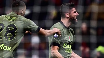 AC Milan's French forward Olivier Giroud (R) celebrates after opening the scoring during the Italian Serie A football match between AC Milan and Torino (AFP)
