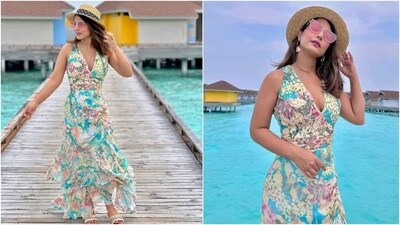 Regarding Hina's sleeveless dress, it comes decorated with floral patterns in blue, pink, peach, grey and yellow hues. It also features cut-out patterns on the bodice, a sheer panel on the waistline, cinched detail under the bust, a flowy skirt, ruffles, an asymmetric hemline, and a plunging neckline flaunting her décolletage. (Instagram) Regarding Hina's sleeveless dress, it comes decorated with floral patterns in blue, pink, peach, grey and yellow hues. It also features cut-out patterns on the bodice, a sheer panel on the waistline, cinched detail under the bust, a flowy skirt, ruffles, an asymmetric hemline, and a plunging neckline flaunting her décolletage. (Instagram)