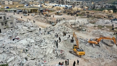Rescuers searching for survivors amidst the rubble of collapsed buildings in Syria. (AFP)