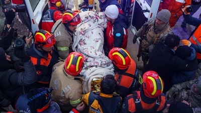 Turkish rescue workers carry Ergin Guzeloglan to an ambulance after pulling him out from a collapsed building in southern Turkey on Saturday, (AP) Turkish rescue workers carry Ergin Guzeloglan to an ambulance after pulling him out from a collapsed building in southern Turkey on Saturday, (AP)