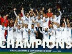 Real Madrid's Karim Benzema lifts the trophy with teammates and coach Carlo Ancelotti after winning the FIFA Club World Cup final