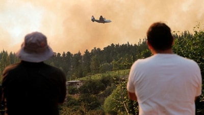 A 10 Tanker DC-10 fire plane throws water over a forest fire in Quirihue, Nuble Region, in Chile. (AFP) A 10 Tanker DC-10 fire plane throws water over a forest fire in Quirihue, Nuble Region, in Chile. (AFP)