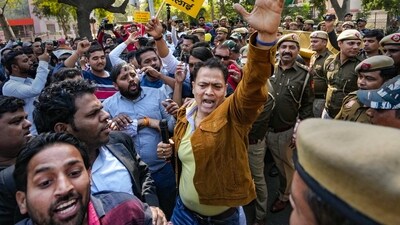 New Delhi: AAP workers raise slogans during their protest over Adani row, near AAP headquarters in New Delhi, Sunday. (PTI) New Delhi: AAP workers raise slogans during their protest over Adani row, near AAP headquarters in New Delhi, Sunday. (PTI)