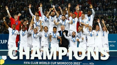 Real Madrid's Karim Benzema lifts the trophy with teammates and coach Carlo Ancelotti after winning the FIFA Club World Cup final (REUTERS)